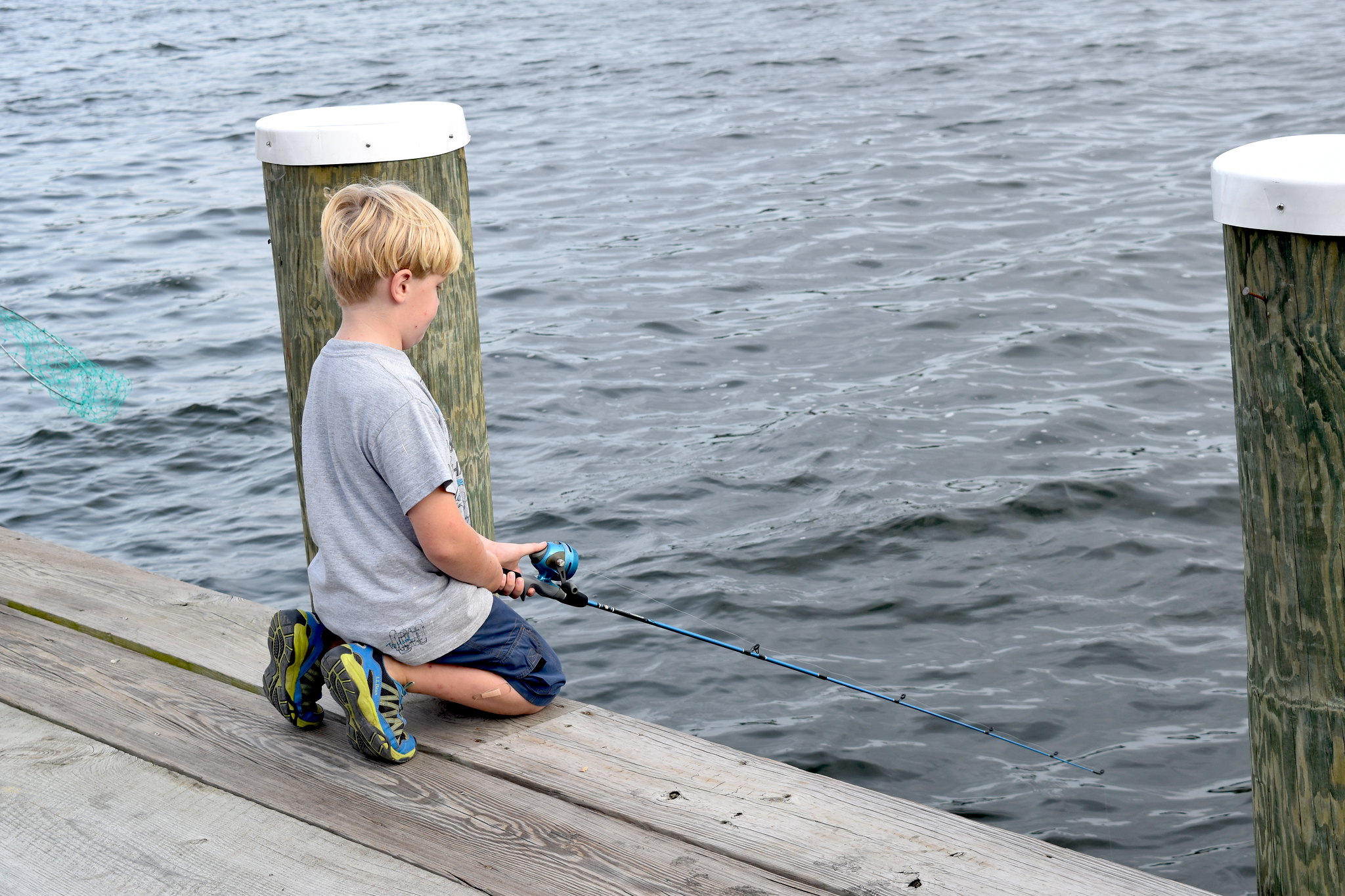 A child fishes at CBMM's campus on a Free Fishing Friday.